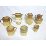 A selection of stoneware pottery including 19th Century Doulton Lambeth three-handled tyg with