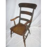 A Victorian elm & beech kitchen carver armchair with rail back and shaped seat on turned tapered