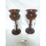 A pair of Victorian ruby tinted glass baluster-shaped table lustres with glass lozenge droplet