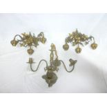 A pair of ornate brass three-branch wall lights with raised floral decoration and one other brass