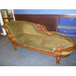 An impressive Victorian style carved mahogany chaise longue with scroll end on turned tapered legs