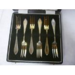 A set of six George V silver cake forks,