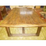 An unusual old large oak rectangular refectory style dining table on square shaped legs,