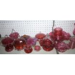 A selection of cranberry tinted glassware including ornamental jars & covers, sweetmeat bowls,