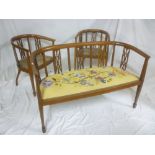 An Edwardian inlaid mahogany three piece parlour suite comprising two seat settee with pierced
