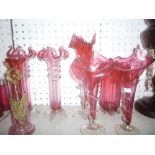 A pair of cranberry tinted glass spill vases with ornate rims and spiral twist decoration,
