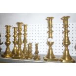 Three pairs of Victorian brass ejector candlesticks with tapered stems and square bases and two