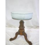 A Victorian carved mahogany and brass mounted circular revolving piano stool on tripod base
