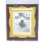 An ornate gilt rectangular picture frame decorated in relief with leaves and flowers 14" x 12"