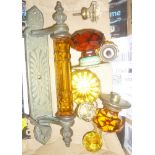 An old brass door fitting with amber glass handle, various other glass mounted handles and knobs,