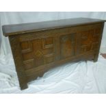 An 18th Century carved and inlaid oak rectangular coffer with triple panelled front and hinged lid