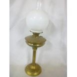 A good quality brass oil lamp with column stem and opaque glass shade