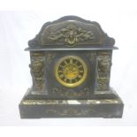 A large Victorian mantel clock with gilt decorated circular dial in polished black slate & brass