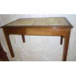 A polished mahogany glass top coffee table with a drawer in one end on square legs
