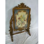 A Victorian carved walnut rectangular fire screen with inset needlework,
