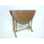 Small Victorian walnut oval drop leaf Sutherland table on bobbin turned supports