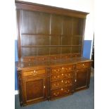 A George III oak and mahogany cross banded break-front dresser with four central graduated drawers