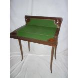 An ornate Edwardian inlaid mahogany double opening card table with baize lined playing surface on
