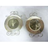 A pair of Edward VII circular photo frames with scroll mounts,