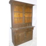 A Victorian stained pine kitchen dresser with two drawers in the frieze and cupboard enclosed by