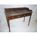 A Victorian mahogany washstand with two drawers in the frieze on turned tapered legs