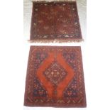 Two small Eastern hand-knotted wool square rugs with geometric decoration on red ground