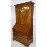An early to mid 19th Century mahogany bureau/bookcase with numerous pigeon holes and drawers