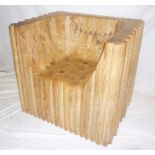 An unusual bespoke carved wood laminate tub chair of square form constructed of roundel pieces in