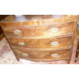 A small mid Victorian mahogany bow front chest of three long drawers with brass ring handles on