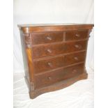 A Victorian mahogany serpentine fronted chest of two short and three long drawers with turned
