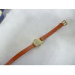 A ladies 18ct gold wristwatch with leather strap