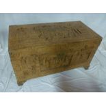 A good quality Eastern carved camphorwood rectangular trunk decorated with numerous character