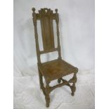 A 19th Century carved oak Carolean-style chair with panelled back and polished seat on turned