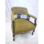 A Victorian carved mahogany tub-style easy chair upholstered in fabric on scroll-shaped legs