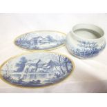 A Continental pottery circular jardiniere with blue and white village scene decoration and a pair