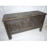 An 18th Century carved oak rectangular coffer with triple panel front,