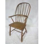An early 19th Century elm & ash Windsor armchair with spindle back and polished wood seat on turned