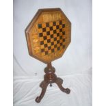 A Victorian inlaid mahogany octagonal tilt top games table with in-set chessboard top on turn