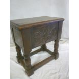A Jacobean-style carved oak rectangular stool with box seat and hinged lid on turned supports