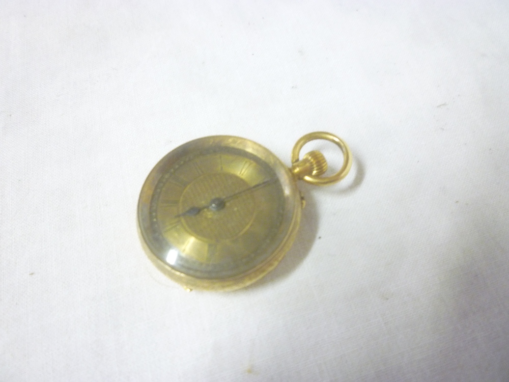 A ladies 18ct gold fob watch with circular decorated dial in engraved case