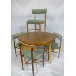 A 1960's teak dining suite comprising four dining chairs with circular upholstered seats and