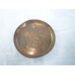 A small copper circular advertising dish,