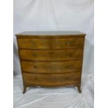 A Victorian figured mahogany bow-front chest of two short and three long drawers with brass ring