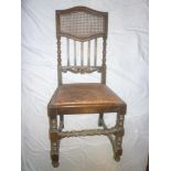 A set of four late Victorian oak dining chairs with cane work panelled backs and upholstered seats