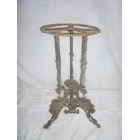 A Victorian cast iron table base with scroll and spindle decoration