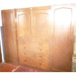 A Victorian mahogany triple wardrobe with central cupboard enclosed by two panelled doors above