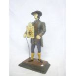 An unusual Spelter mantel clock in the form of a gentleman with wide brimmed hat,