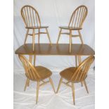A 1960's Ercol light elm rectangular dining table together with four Ercol spindle back dining