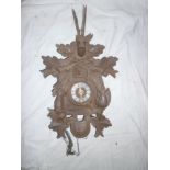 A Continental carved wood Cuckoo clock with raised figure decoration