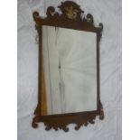 A George III mahogany framed rectangular wall mirror in scroll frame surmounted by a gilt bird